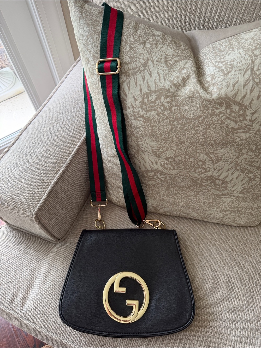 Black Leather Crossbody with Signature Gold Emblem and Green-Red Web Strap